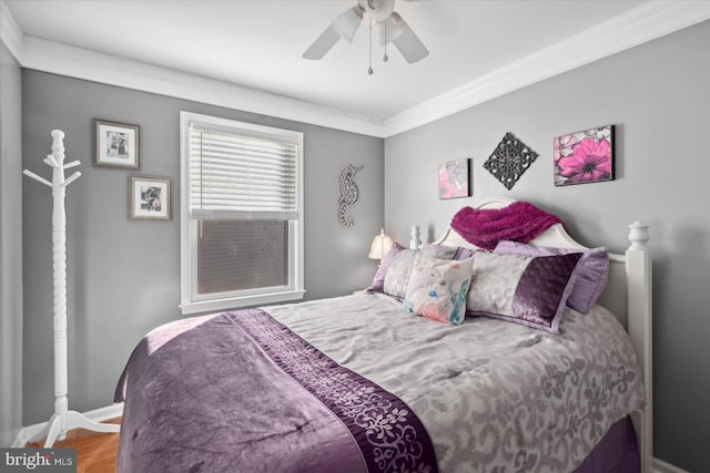 bedroom with hardwood / wood-style floors, ceiling fan, and crown molding