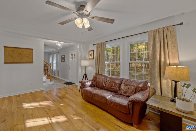 living room with light hardwood / wood-style flooring and ceiling fan