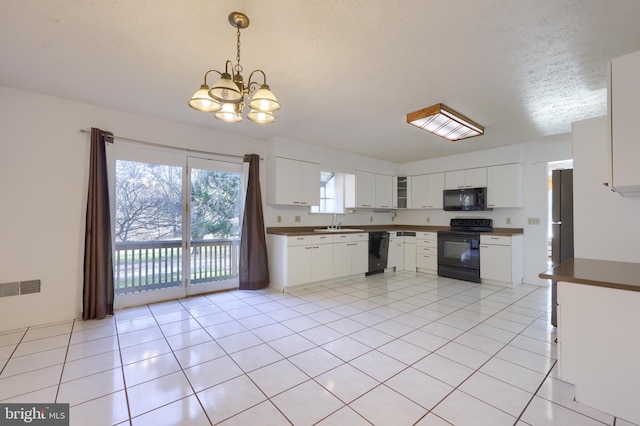 kitchen featuring black appliances, sink, white cabinetry, pendant lighting, and a chandelier