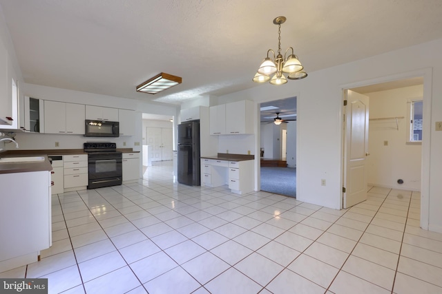 kitchen featuring black appliances, white cabinetry, decorative light fixtures, and ceiling fan with notable chandelier