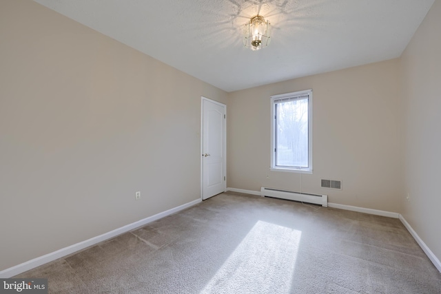 carpeted empty room with a baseboard radiator