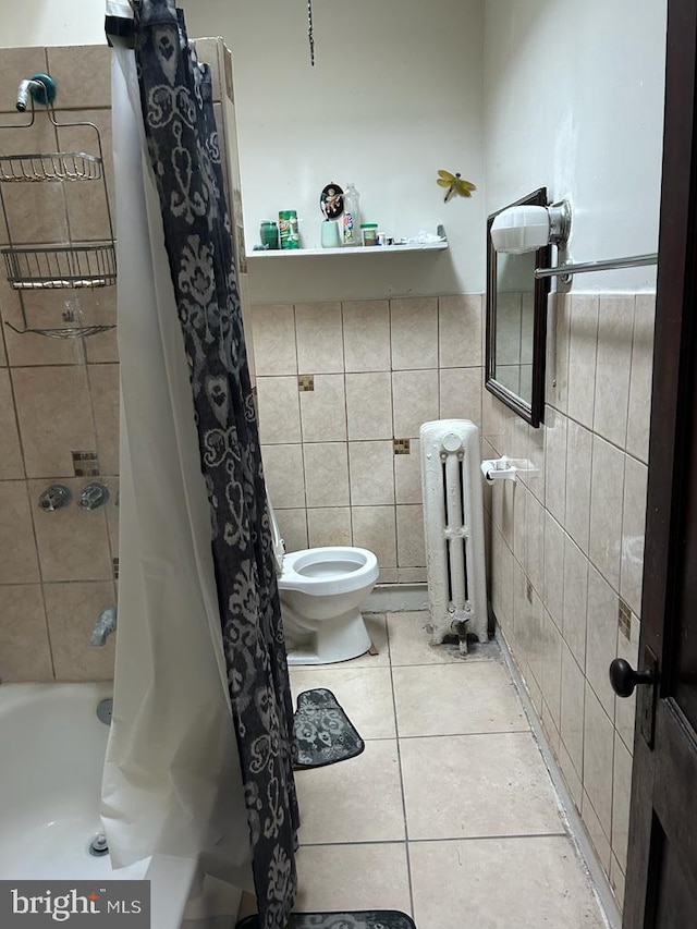 bathroom with radiator heating unit, tile walls, toilet, shower / bath combo, and tile patterned flooring