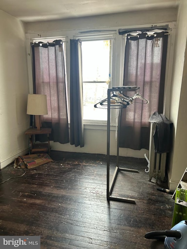 bedroom with dark wood-type flooring