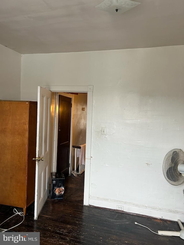 unfurnished room with dark wood-type flooring