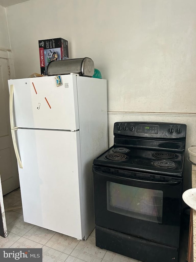 kitchen featuring white fridge and electric range