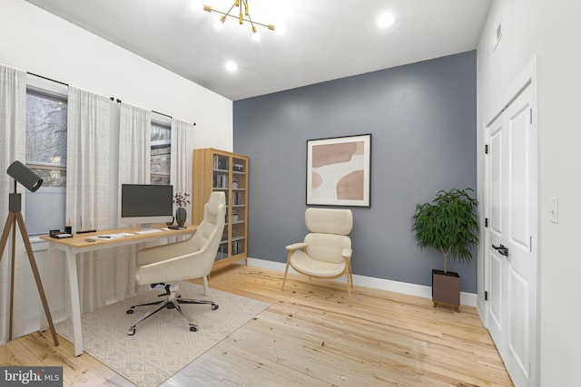 office area featuring a notable chandelier and light hardwood / wood-style flooring