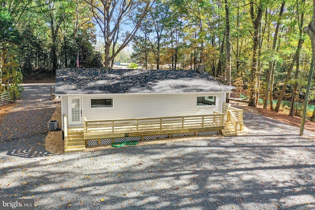 view of property exterior with a deck and central AC unit