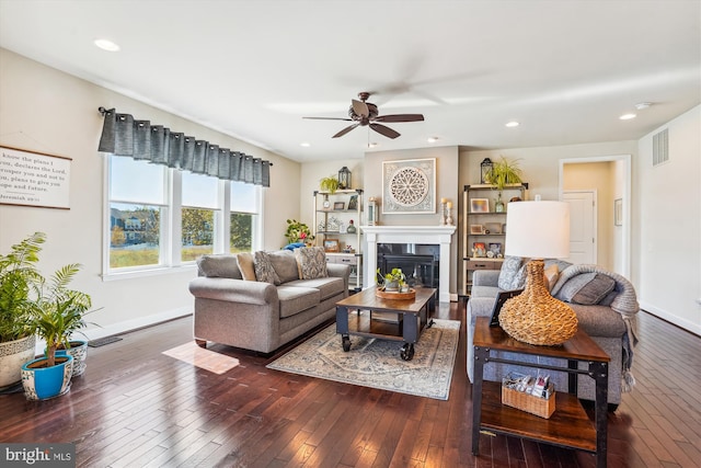 living room featuring dark hardwood / wood-style floors and ceiling fan