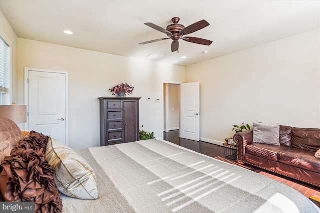 bedroom with dark hardwood / wood-style flooring and ceiling fan