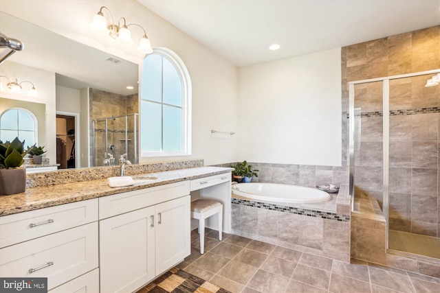 bathroom with tile patterned flooring, plus walk in shower, and vanity