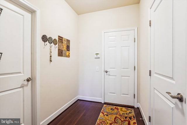 doorway with dark hardwood / wood-style flooring