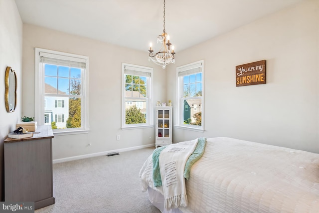 carpeted bedroom with a chandelier