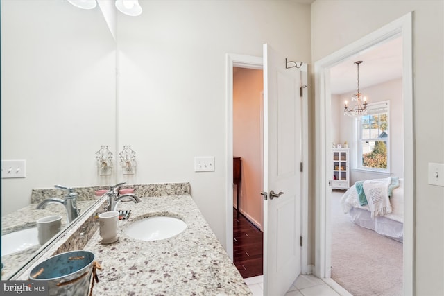 bathroom featuring vanity, tile patterned flooring, and a chandelier