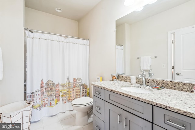 bathroom with vanity, tile patterned flooring, and toilet