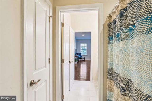 corridor with light tile patterned floors