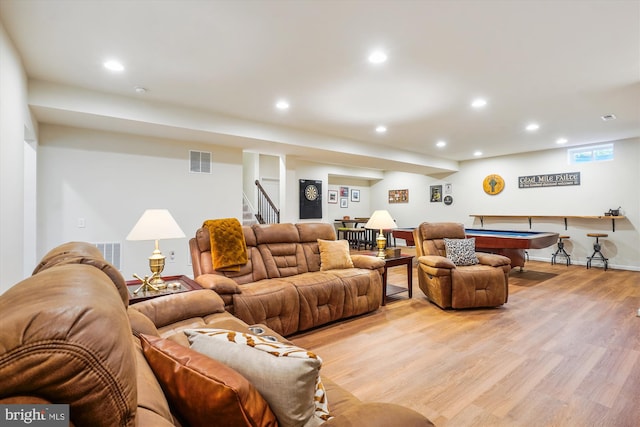 living room with light hardwood / wood-style flooring and billiards