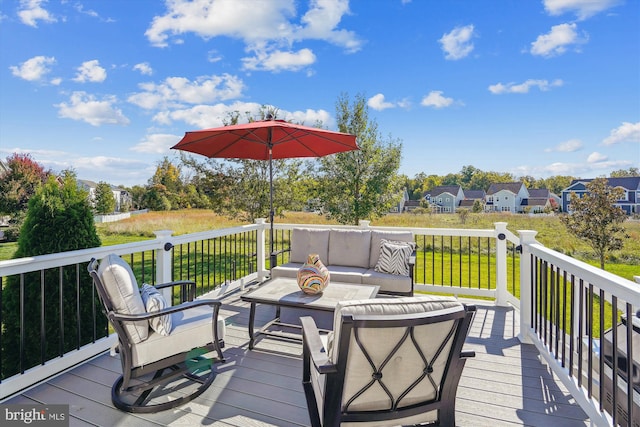 wooden deck with an outdoor hangout area and a lawn