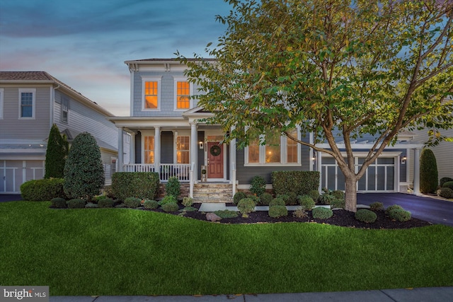 view of front of home with a yard and covered porch