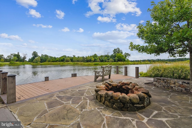 view of dock featuring a patio, a water view, and an outdoor fire pit