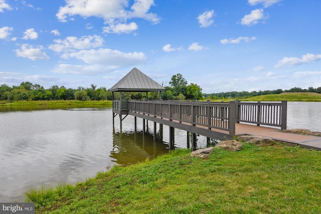 view of dock featuring a gazebo, a water view, and a lawn