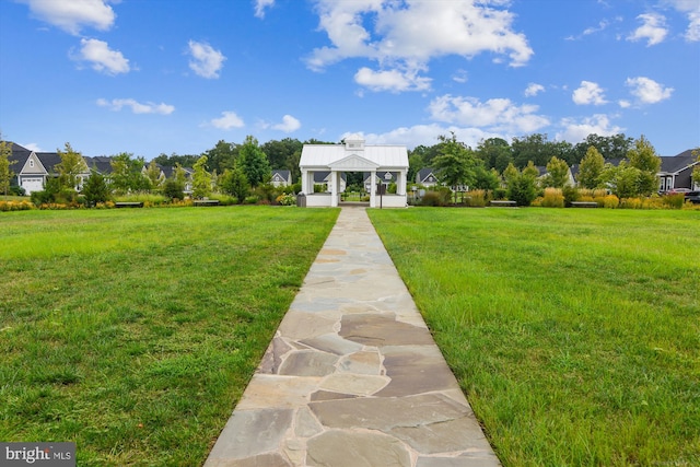 view of front of home with a gazebo and a front lawn