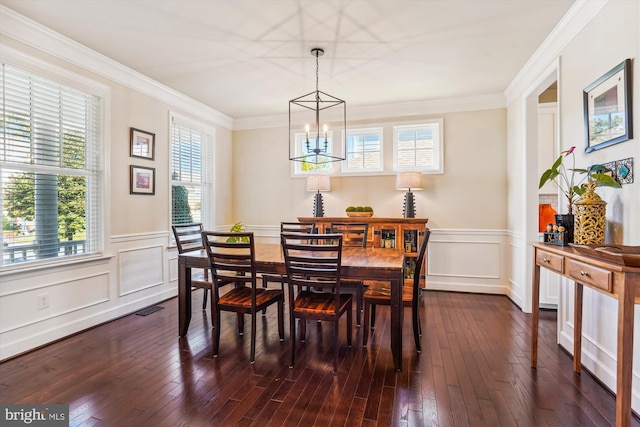 dining room featuring ornamental molding, a notable chandelier, and dark hardwood / wood-style flooring