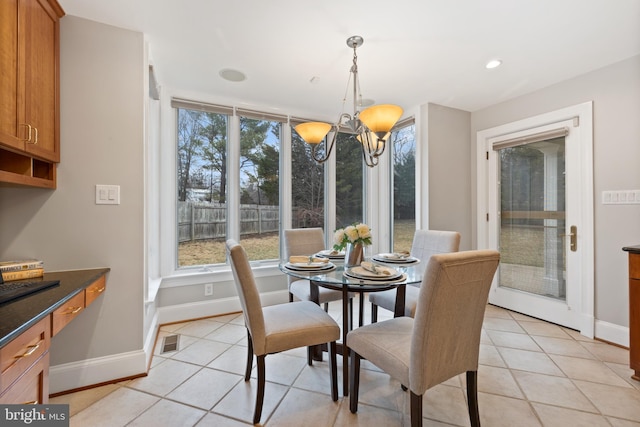 dining area featuring baseboards, visible vents, a chandelier, and light tile patterned flooring