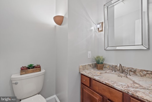 half bath with vanity and toilet