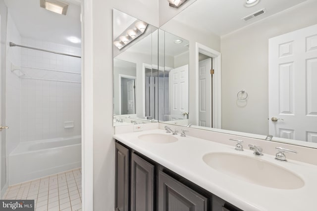 bathroom featuring double vanity, tile patterned flooring, visible vents, and a sink