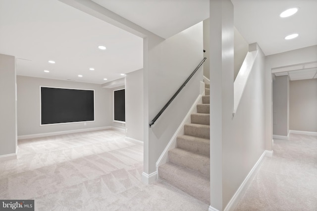 below grade area featuring recessed lighting, carpet flooring, stairway, and baseboards