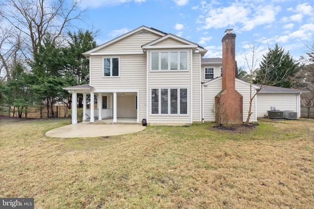 rear view of house with a yard, fence, a patio, and central AC unit