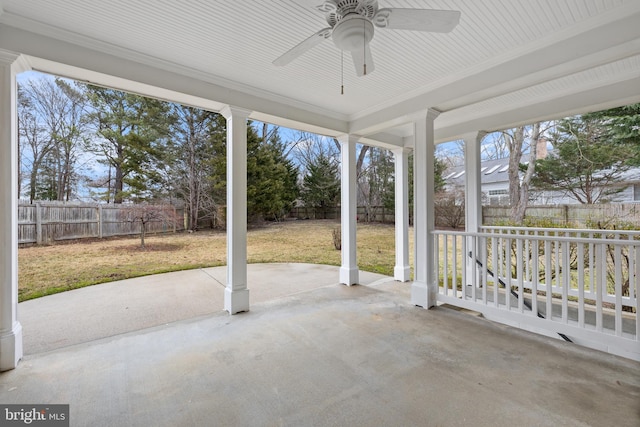 unfurnished sunroom featuring ceiling fan