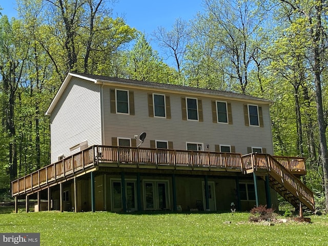 back of property with a deck and a lawn