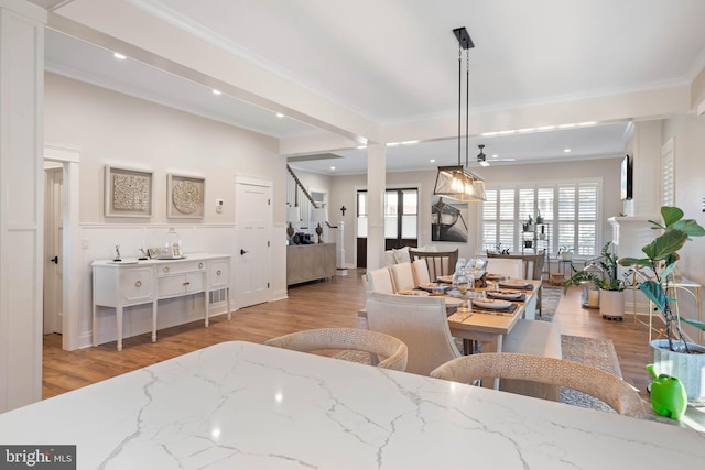 interior space with ornamental molding and light hardwood / wood-style flooring