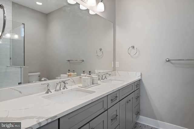 bathroom with toilet, vanity, and a tile shower