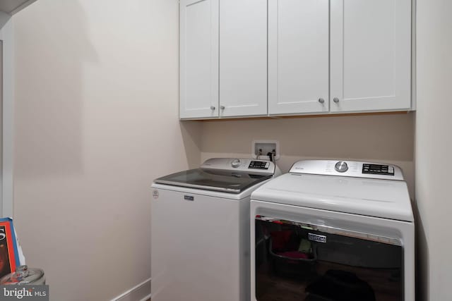 laundry area featuring cabinets and washer and dryer