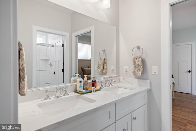 bathroom featuring vanity, hardwood / wood-style flooring, and a shower with shower door