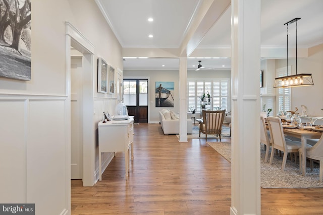 hall featuring wood-type flooring and crown molding