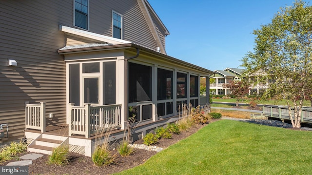 exterior space featuring a lawn and a sunroom