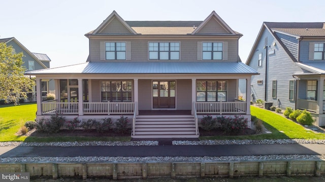 view of front of house featuring central air condition unit, a front yard, and covered porch