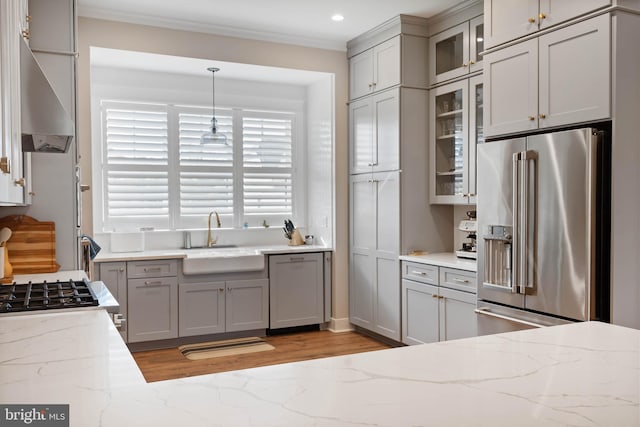 kitchen with gray cabinetry, sink, pendant lighting, and high end fridge