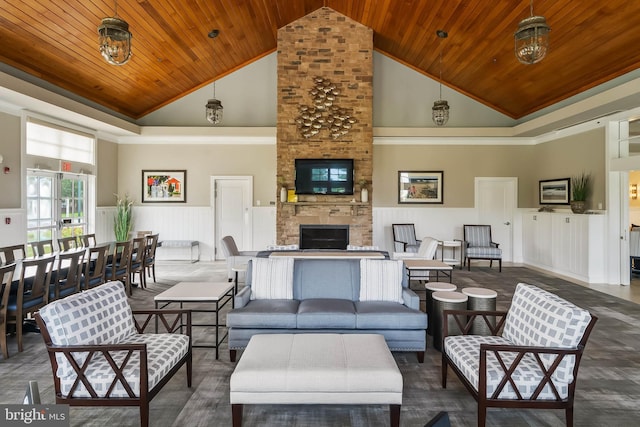 living room featuring a stone fireplace, wood ceiling, and high vaulted ceiling