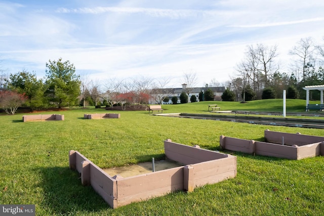 view of property's community with a lawn