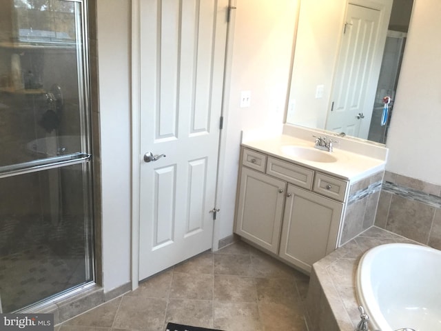 bathroom featuring vanity, plus walk in shower, and tile patterned flooring