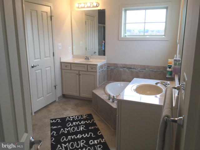 bathroom with vanity, tiled bath, and tile patterned floors