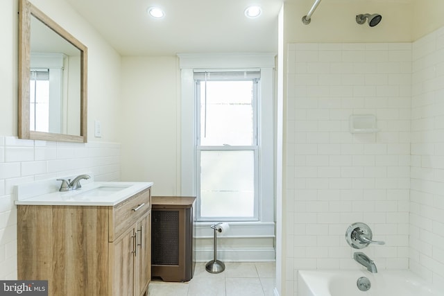 bathroom with tiled shower / bath, vanity, a wealth of natural light, and tile patterned flooring