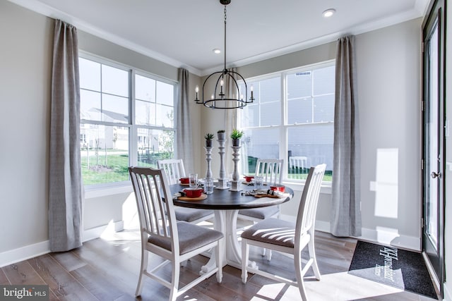 dining room featuring crown molding, hardwood / wood-style floors, and a chandelier