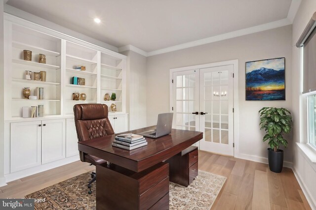 home office featuring crown molding, light hardwood / wood-style floors, and french doors