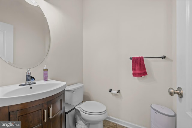 bathroom with vanity, toilet, and tile patterned floors