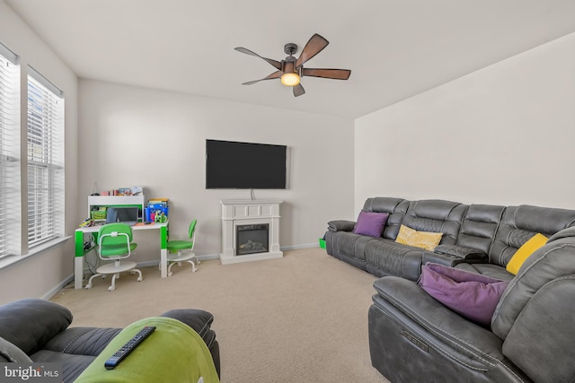 carpeted living room with ceiling fan